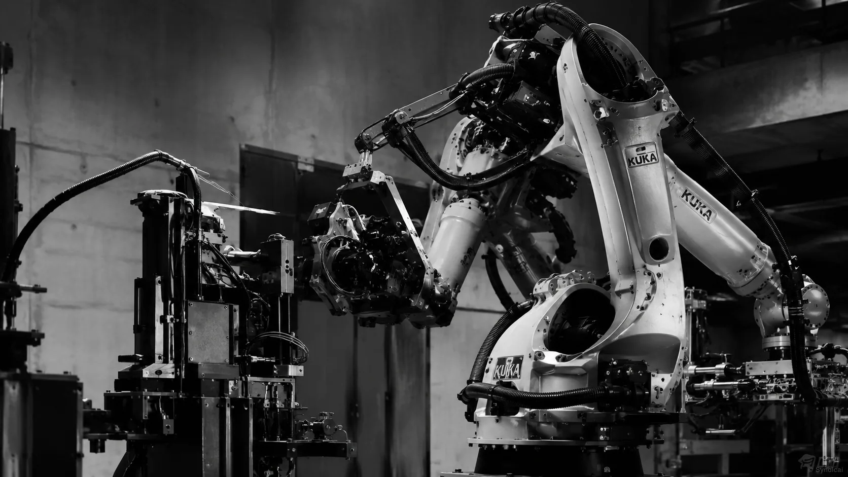 Robotic arms working an automated assembly cell